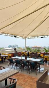 a group of tables and chairs under a large umbrella at Akaya Elegance in Ahmadnagar +63 photos
