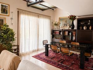 a living room with a table and chairs at Sunshine Luxury Apartment - spacious house - Lake View - Pool in Padenghe sul Garda