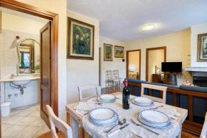 a dining room and kitchen with a table and chairs at Tenuta Di Litiano Villa with Garden and Pool - Happy Rentals in Roccastrada