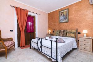 a bedroom with a bed and a chair and a window at Tenuta Di Litiano Villa with Garden and Pool - Happy Rentals in Roccastrada +31 photos
