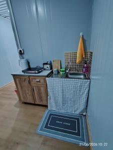 a kitchen with a sink and a counter top at DMaro Cabin in Kampong Kundassan