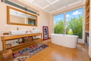 a bathroom with two sinks and a large window at Paradis Relais Infinity Pool Lake View in Belgirate +32 photos