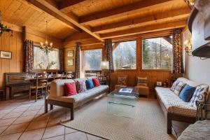 a living room with couches and a table at Chalet du Brevent ski in - ski out - Happy Rentals in Chamonix