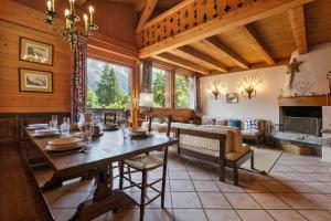 a dining room with a table and a fireplace at Chalet du Brevent ski in - ski out - Happy Rentals in Chamonix