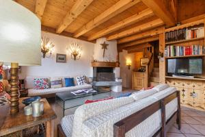 a living room with two couches and a fireplace at Chalet du Brevent ski in - ski out - Happy Rentals in Chamonix