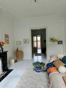a living room with a couch and a table at Elegant Manor House in Tongeren