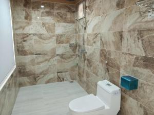 a bathroom with a toilet and a shower at Rice Fields Mountain Homestay in Vũ Lâm +37 photos