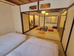 a room with two beds and a living room at Rinku Base Ichi in Tajiri