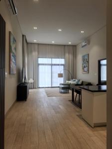 a living room with a table and a couch at Tulip River View in Ma‘mūrah