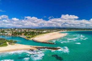 an aerial view of a beach in the ocean at Kingscliff Spacious Beach Cottage in Kingscliff