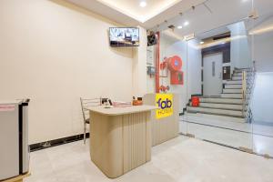a lobby with a counter and a tv in a room at FabHotel RR Inn in Kānpur