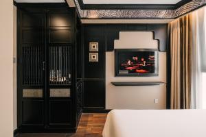 a living room with black walls and a white table at Bay Luxury Fortune Grand Hotel in Hanoi