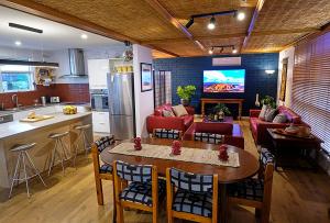 a kitchen and a living room with a table and a couch at Oasis at Aldinga Beach in Aldinga Beach