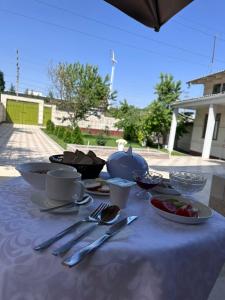 a table with a blue table cloth with food on it at River guest house in Osh +15 photos