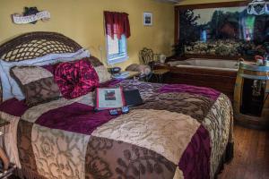 a bedroom with a bed with a laptop on it at Featherbed Railroad in Upper Lake