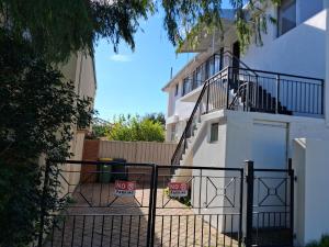 a gate with a no entry sign in front of a building at Como Beach Apartment 2 in Perth +2 photos