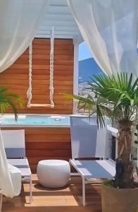 a living room with white furniture and a swimming pool at One 360 Skyline Athens Penthouses in Athens +65 photos