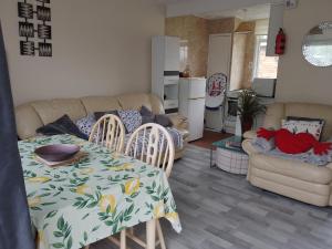 a kitchen and living room with a table and chairs at SHORTIEs STAYS in Hemsby +22 photos