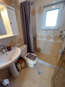 a bathroom with a toilet and a sink and a window at The Mastiha Spot 8 in Chios +43 photos