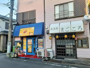 a building with asian signs on the side of a street at The Scene Fuchinobe in Sagamihara
