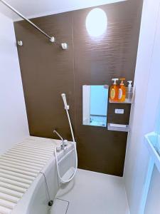 a bathroom with a toilet and a sink and a mirror at The Scene Fuchinobe in Sagamihara +19 photos