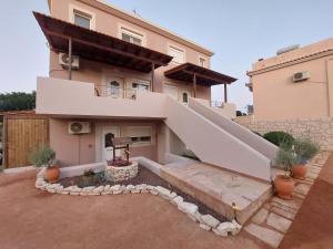 a house with a staircase in front of it at The Mastiha Spot 8 in Chios
