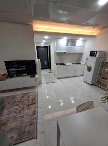 a large kitchen with white cabinets and appliances at إقامة مريحة وممتعة في شارع الاميرات in Baghdād