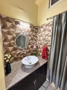 a bathroom with a sink and a mirror at Unique Nest Homestay in Guwahati