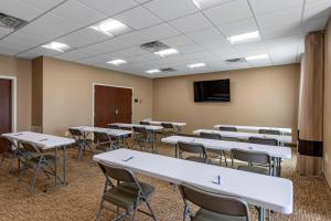 a classroom with tables and chairs and a tv at Comfort Inn & Suites Charlottesville Hollymead Town Center in Charlottesville