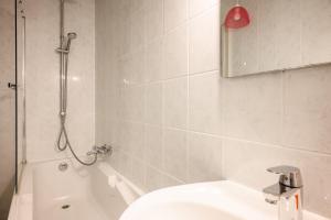 a bathroom with a tub and a toilet and a sink at Chez Romane in Riquewihr +16 photos