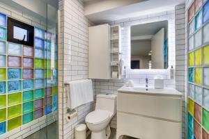 a bathroom with a toilet and a sink and a mirror at Comfort Suites Tijuana in Tijuana +75 photos