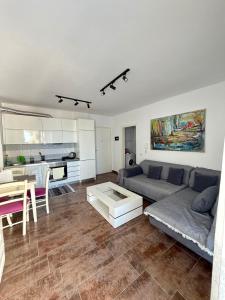 a living room with a couch and a table at Seaview Apartment in Dhërmi +12 photos