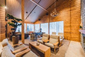 a living room with wood paneled walls at Wilderness Hotel Saariselkä in Saariselka