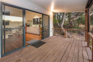 an empty house with a deck with a tree at Lake View Cottage in Metricup