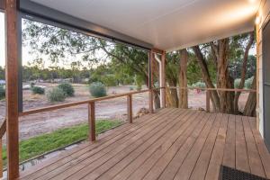 a wooden porch with a view of a tree at Lake View Cottage in Metricup