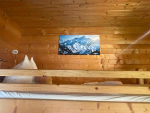 a bedroom with a wooden wall with a television on it at Schlossnerhof in Virgen