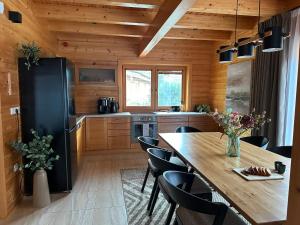 a kitchen with a large wooden table and chairs at Chata Mila in Veľká Lomnica