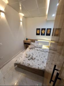 a bedroom with a bed with white sheets at إقامة مريحة وممتعة في شارع الاميرات in Baghdād