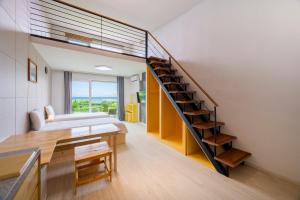 a room with a staircase and a living room at Jeju Turning point Pension in Seogwipo
