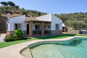a house with a swimming pool in front of a house at El Rincón de Esther in Cómpeta