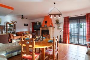a living room with a table and a fireplace at La Majailla in Peal de Becerro