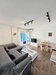 a living room with a couch and a table at Seaview Apartment in Dhërmi