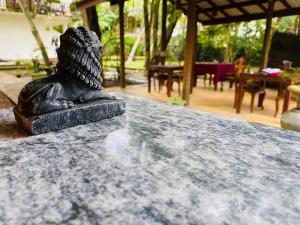 a statue sitting on top of a table at Raniya Villa in Bentota