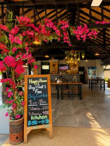 a restaurant with a chalkboard sign with pink flowers at Peace Garden Resort, Koh Samui in Bangrak Beach