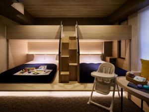 a bedroom with two bunk beds and a sink at Minn Namba Nipponbashi in Osaka