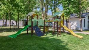 a playground with a slide in the grass at Kraimorie Park in Burgas