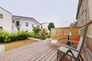 a wooden deck with a table and chairs on it at Appartement rénové centre Crozon in Crozon