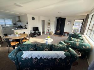 a living room with a couch and a table at B&B on Hoffman in Hokitika