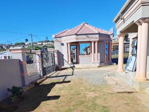a house with a gate in front of it at Zamdu Lodge in Nkandla +34 photos