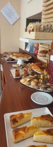 a buffet line with different types of food on plates at Hotel b&b Villa Irma in Rimini +33 photos